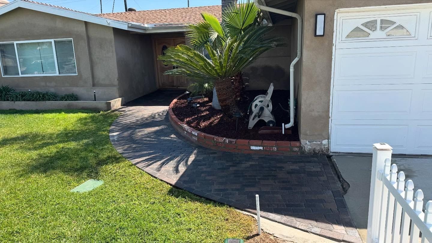 A house with a white garage door and a bench in front of it.